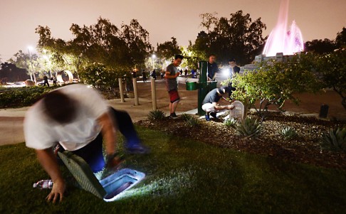 People look for hidden cash around the Mulholland Memorial Fountain. Photo: Reuters
