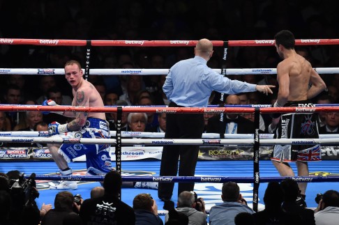 George Groves goes on one knee after being knocked down by Carl Froch. Photo: AFP