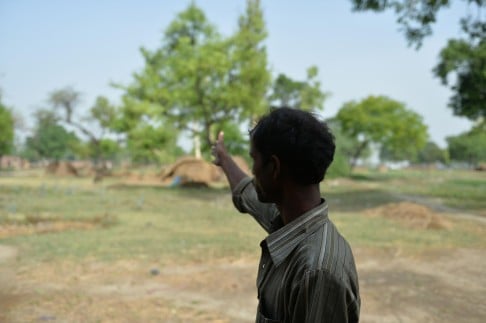 A man near the tree where his daughter was hanged. Photo: AFP