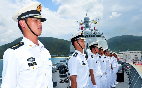 Chinese naval soldiers stand on China's missile destroyer Haikou at a naval port in Sanya, Hainan. The Chinese naval squadron has left port to take part for the first time in the world's largest naval exercises hosted by the U.S. in waters near Hawaii. Photo: AP