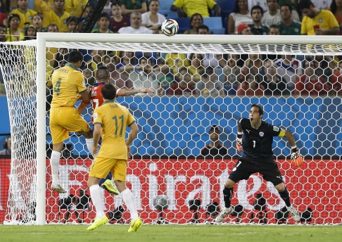 Tim Cahill leaps to head Australia back in the game. Photo: AP