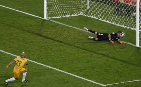 Chile keeper Claudio Bravo makes a crucial save from Mark Bresciano to keep the score 2-1. Photo: Reuters