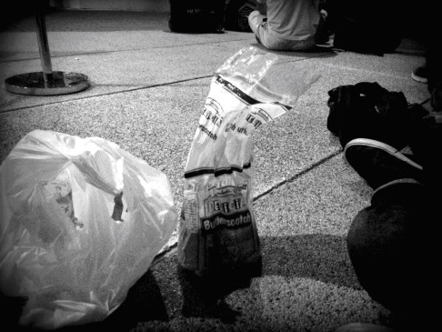 Sharing bread and water with members of the media outside one of the hotels in Putrajaya where some of the Chinese family members were staying. Photo: Satish Cheney