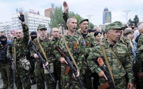 Pro-Russian militants salute as they take an oath in Donetsk, Ukraine on Saturday. Photo: AFP