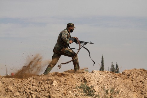 A Shiite fighter clashes with Sunni-dominated Free Syrian Army rebels near Damascus. Photo: AP