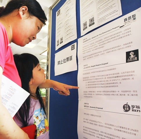 A mother and her daughter read the proposals. Photo: Edward Wong