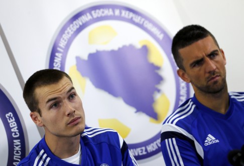 Bosnia's Toni Sunjic (left) and Vedad Ibisevic field medai questions ahead of their match against Iran at Pituacu stadium in Salvador. Photo: Reuters 