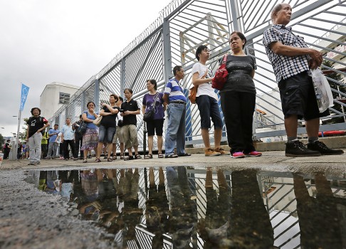 People queue up at a polling centre to vote in an unofficial referendum on democratic reform. Photo: AP