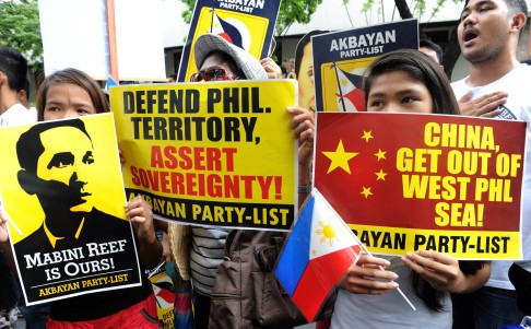 Filipino protesters display placards during a rally against China's claim to areas of the South China Sea. Photo: AFP