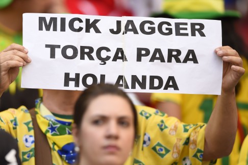 Brazil fans urge Mick to support the Netherlands. Photo: AFP