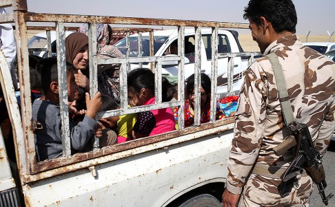 An Iraqi family who fled their village arrive at a Kurdish security forces checkpoint in Khazer, between Mosul and Arbil. Photo: AP