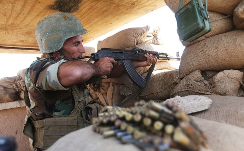 A Kurdish peshmerga fighter takes his position on the front line with ISIL militants in Tuz Khormato, 100km south of Kirkuk. Photo: AP