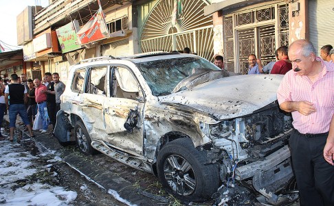 A damaged car at the scene of an explosion in Kirkuk. Photo: Xinhua