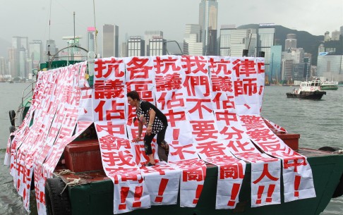A barge at Tsim Sha Tsui pier is draped in banners supporting the jump into the harbour in protest at Occupy Central. Photo: Dickson Lee