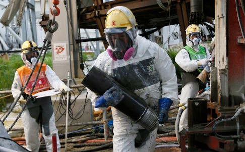 Workers at the crippled reactor buildings at the Fukushima nuclear power earlier this month. Photo: AFP