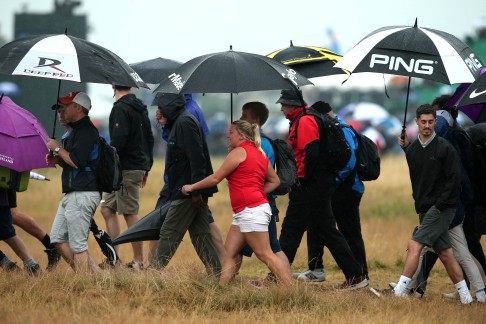 Spectators shelter from the rain at Royal Liverpool Golf Course in  Hoylake. Photo: AFP