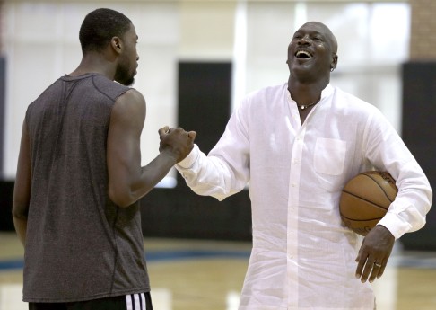 Charlotte Hornets owner Michael Jordan laughs with forward Michael Kidd-Gilchrist (left) during a workout in Charlotte, North Carolina.  Photo: AP