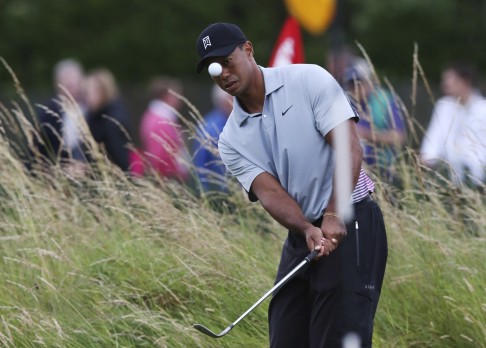 Tiger Woods watches his shot on the practice chipping green ahead of the British Open. Photo: AP 