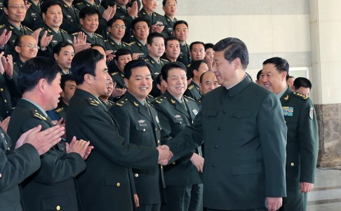 President Xi Jinping, who also serves as chairman of the Central Military Commission, shakes hands with PLA division commanders in Shandong province last year. Photo: Xinhua