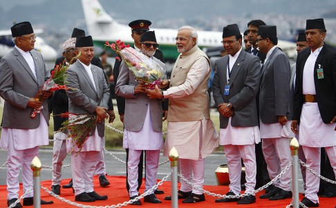 Modi (centre) receives a bouquet from his Nepalese counterpart. Photo: Reuters
