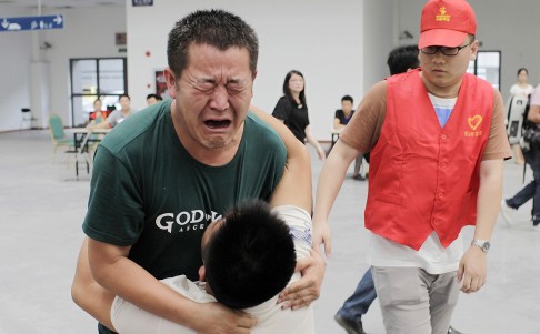 Family members cry at a caring centre for relatives of victims of a factory explosion, in Kunshan, Jiangsu province. Photo: Reuters