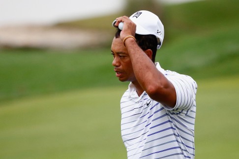 Tiger Woods tips his cap after finishing his second round. Photo: AFP
