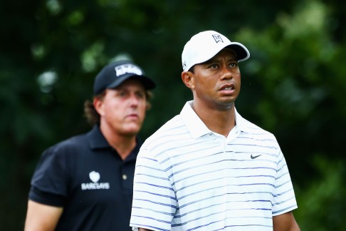 Tiger Woods  and Phil Mickelson  walk off the 18th green. Photo: AFP
