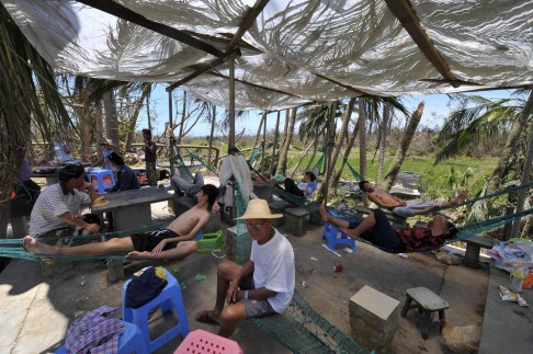 Residents rest in a makeshift shelter. Photo: AFP