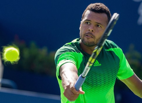 Jo-Wilfried Tsonga returns a shot to Roger Federer. Photo: AFP
