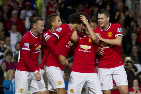 United's Marouane Fellaini (centre left) celebrates with teammates after scoring against Valencia during a preseason friendly at Old Trafford. Photo: AP 
