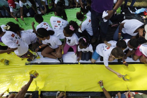 Children paint during an event in January in Panama City as part of celebrations for the 100-year anniversary of the Panama Canal. The event broke a Guinness World Record, with 5,084 children painting a massive mural together at the same time for three minutes. Photo: Reuters