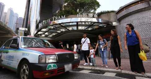 People queue at a taxi stand outside the Peak Tram terminal in Central. Photo: Jonathan Wong