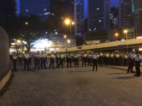 Police officers line up between Central and Admiralty. Photo: Ernest Kao