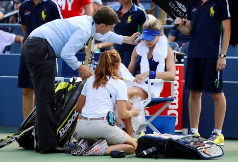 Eugenie Bouchard receives medical attention during her loss to Ekaterina Makarova. Photo: AFP