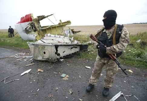 A pro-Russian separatist stands at the crash site of Malaysia Airlines flight MH17, near the settlement of Grabovo in the Donetsk region. Photo: Reuters