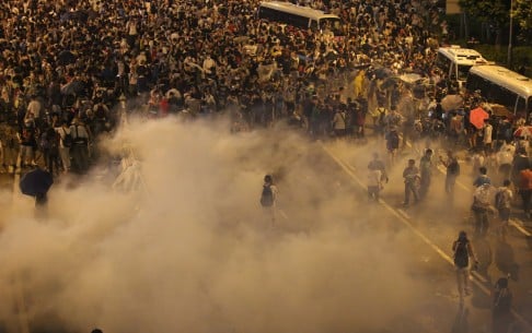 A lone protester stands amid plumes of tear gas. Photo: Sam Tsang