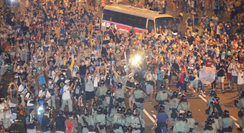 Protesters raise their hands in the air to express non-violent protest. Sam Tsang