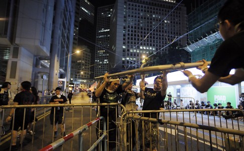 Protesters fortify barricades to block streets in Central late on Monday. Photo: AP