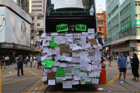 A bus covered by pro-democracy messages left by demonstrators in Nathan Road, Mong Kok. Photo: K.Y. Cheng