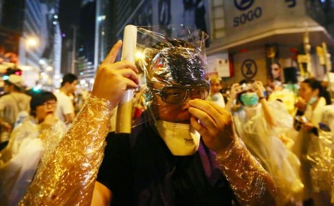 Protesters in Causeway Bay covered themselves in cling wrap at midnight to ready themselves for any police action. Photo: Sam Tsang