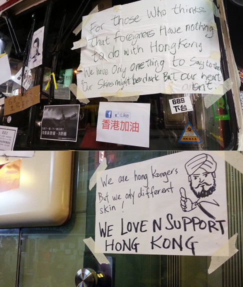 Posters stuck onto one of six vacated buses on Nathan Road and a nearby HSBC building.