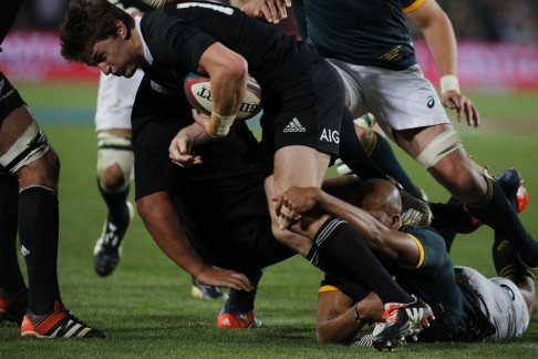 All Blacks fly-half Beauden Barrett is tackled during the final phase of their match against South Africa. Photo: AFP