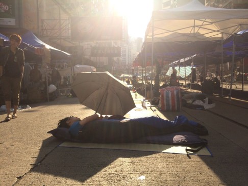 A protester sleeps as the sun rises in Causeway Bay. Photo: Danny Lee
