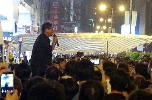 Lawmaker Wong Yuk-man gives a short speech in Mong Kok. Photo: Danny Mok