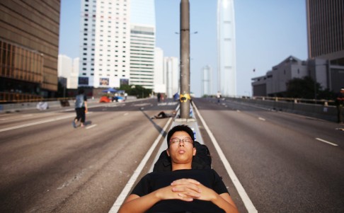 A protester sleeps on an island Harcourt Road in Admiralty. Photo: Robert Ng