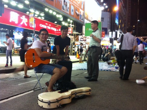 Guitar teacher Bernard Yim plays at the protest site in Causeway Bay. Photo: Raquel Carvalho