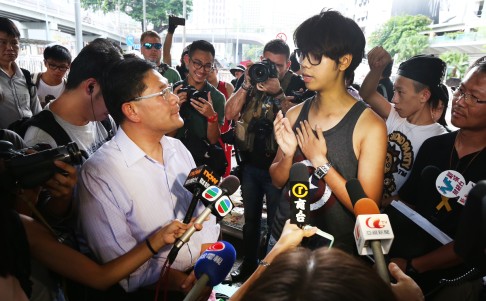 Yip Wing-shing, chairman of Central and Western District Council, talks to student Eddy Chan. Photo: David Wong