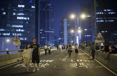 Protesters walk along an occupied road outside Hong Kong's Central Government Office in Hong Kong. Photo: EPA