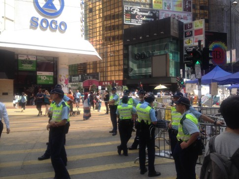 Police officers gather outside Sogo in Causeway Bay. Photo: Alan Yu