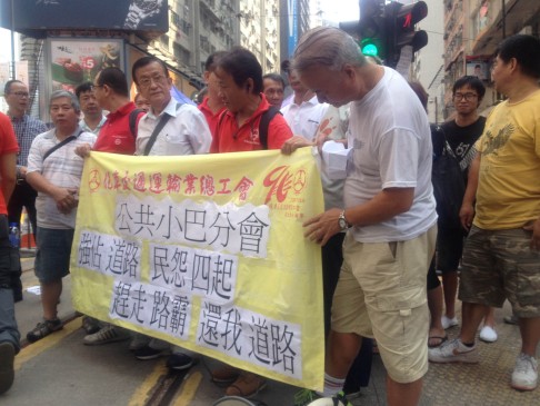 Red minibus drivers demand that barricades be removed in Causeway Bay. Photo: Alan Yu